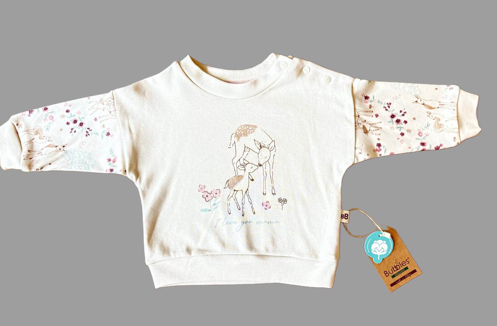 Organik pamuktan üretilmiş kız bebek 3’lü takım – şapka, sweatshirt ve pantolondan oluşur; 3-18 ay arası kullanım için uygundur, yumuşak ve konforlu yapısıyla günlük kullanıma idealdir.